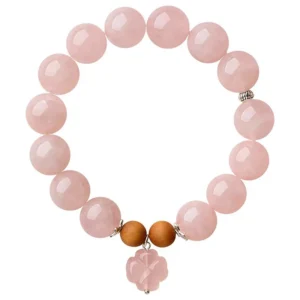 Natural Rose Quartz bracelet with flower charm for Love & Harmony on white background
