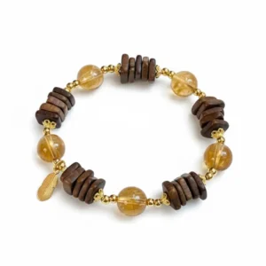Natural Citrine bracelet for Wealth & Success with dark wood accents and gold feather charm on white background