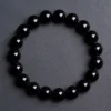 Natural Obsidian bracelet for Protection & Grounding on dark grey background