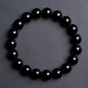 Natural Obsidian bracelet for Protection & Grounding on dark grey background