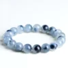 Natural Blue Rutilated Quartz bracelet for Wealth & Success on white background