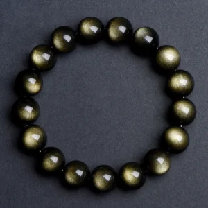Natural Golden Sheen Obsidian bracelet for Protection & Manifestation on dark gray background