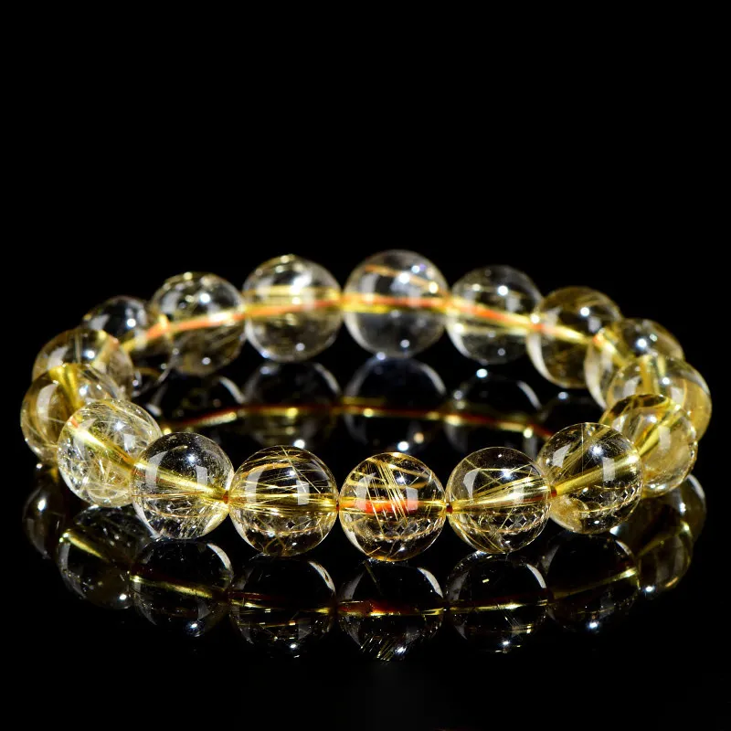 SCPGRU01P1 Natural Rutilated Quartz bracelet for Wealth & Success on black reflective background