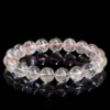 Natural Rutilated Quartz bracelet for Wealth & Success on black background