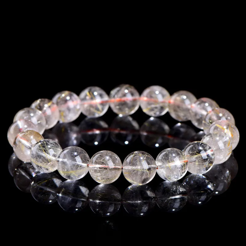 Natural Rutilated Quartz bracelet for Wealth & Success on black background