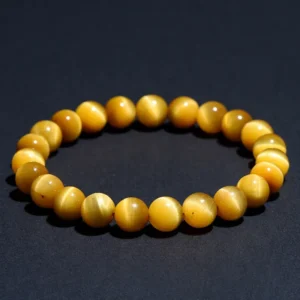 Natural Tiger's Eye bracelet for Protection & Grounding on dark background
