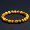Natural Tiger's Eye bracelet for Protection & Grounding on dark background