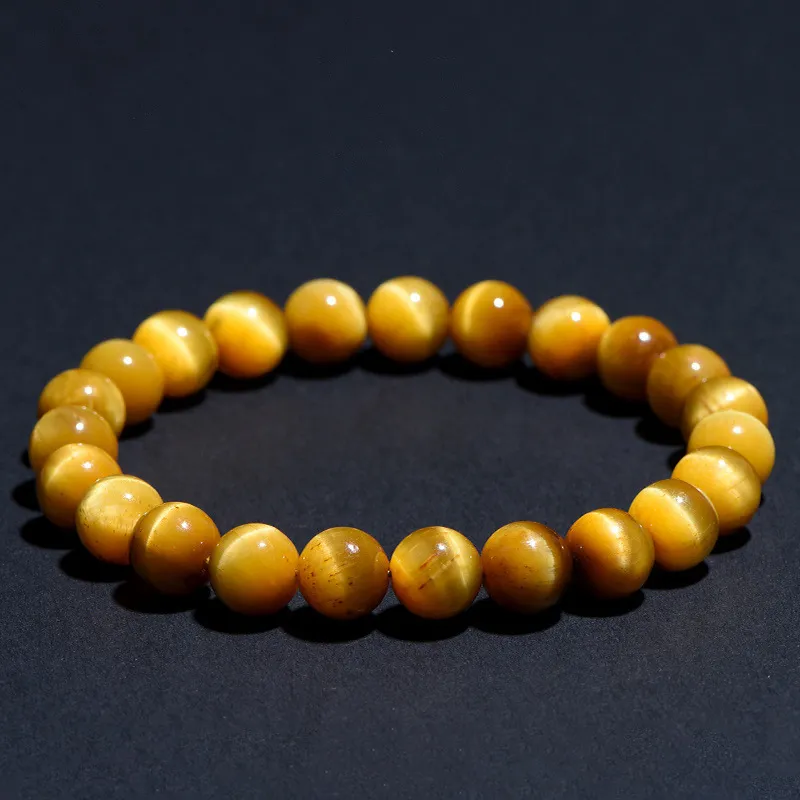 Natural Tiger's Eye bracelet for Protection & Grounding on dark background