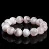 Natural White Phantom Quartz bracelet for Wealth & Success on black reflective background
