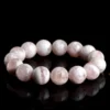 Natural White Phantom Quartz bracelet for Wealth & Success on black reflective background