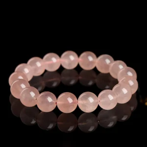 Natural Rose Quartz bracelet for Love & Harmony on black reflective background