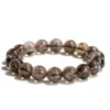 Natural Smoky Quartz bracelet for grounding and protection showing translucent brown beads with rainbow inclusions on white background
