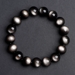 Natural Silver Sheen Obsidian bracelet for Protection & Inner Clarity on dark gray background