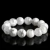 Natural Phantom Quartz bracelet for Wealth & Success on black reflective background