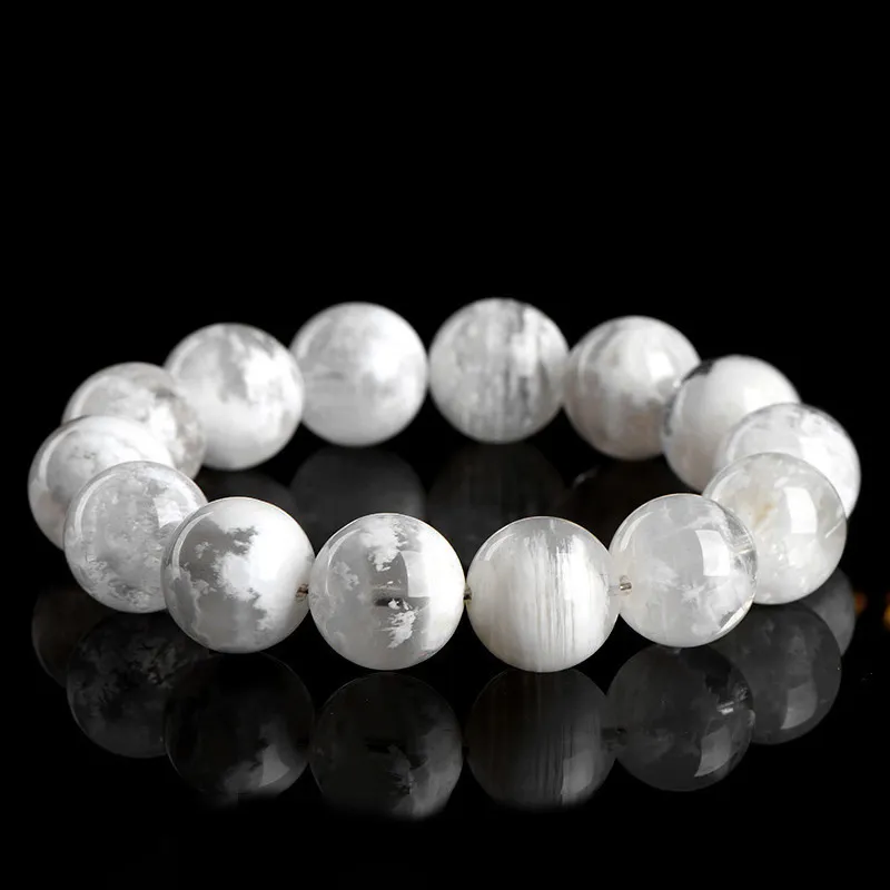 Natural Phantom Quartz bracelet for Wealth & Success on black reflective background